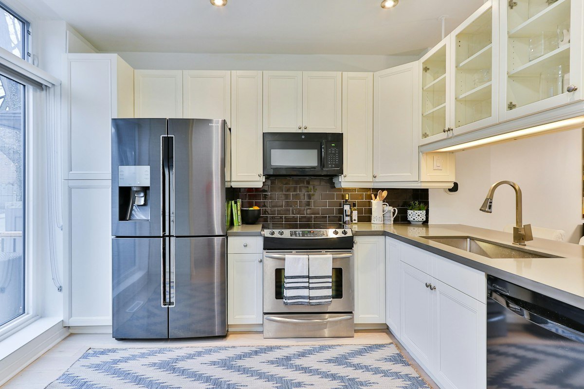 Modern stainless steel refrigerator not cooling in kitchen